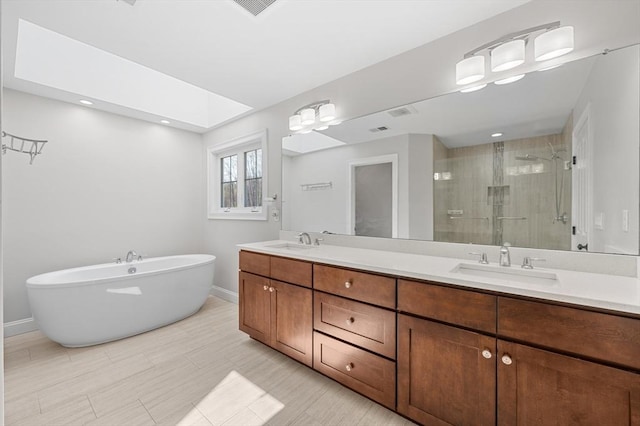 full bath featuring baseboards, a sink, a stall shower, and double vanity