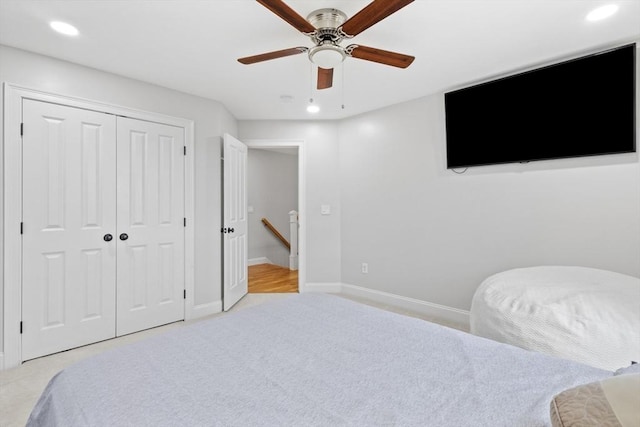 bedroom with baseboards, a closet, recessed lighting, and light colored carpet