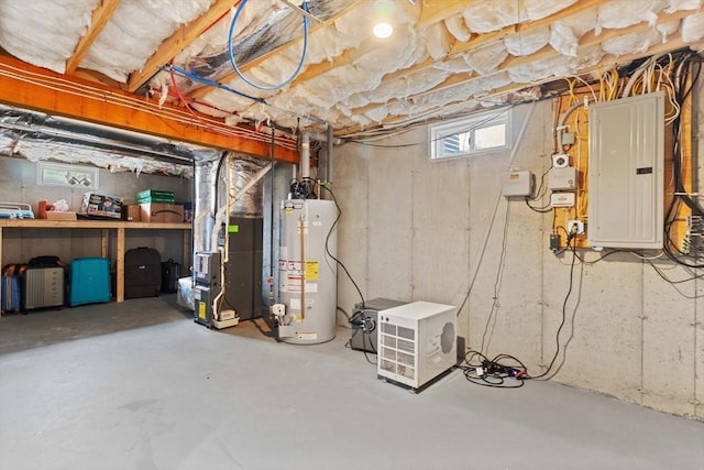 basement featuring heating unit, a wealth of natural light, water heater, and electric panel