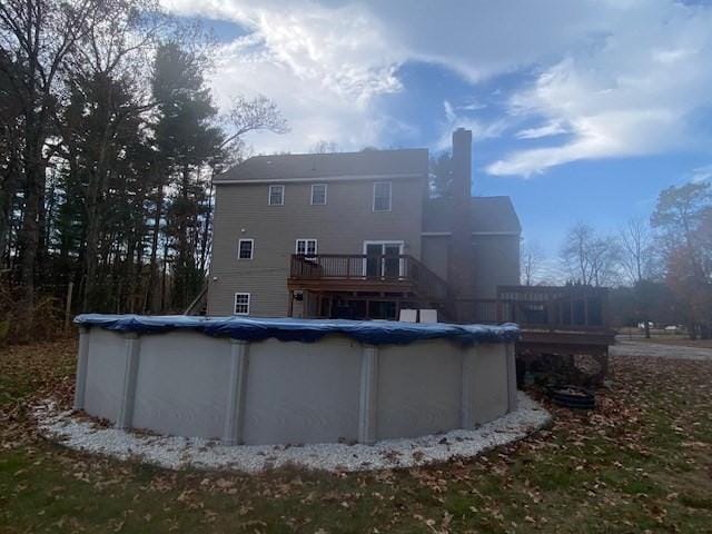 back of house with a swimming pool side deck