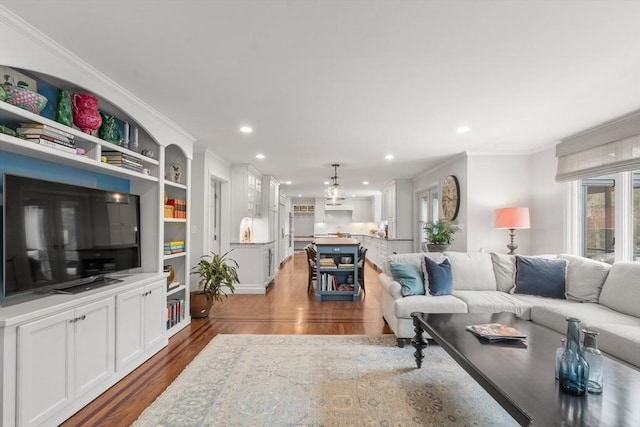 living area featuring dark wood-style flooring, recessed lighting, and crown molding