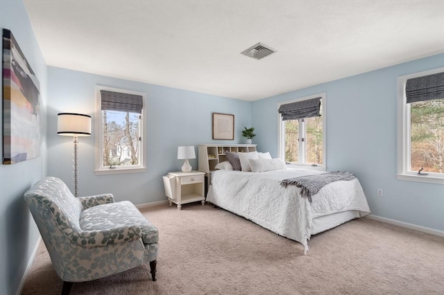 bedroom with baseboards, visible vents, and carpet flooring