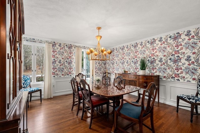 dining space featuring a wainscoted wall, dark wood-type flooring, and wallpapered walls