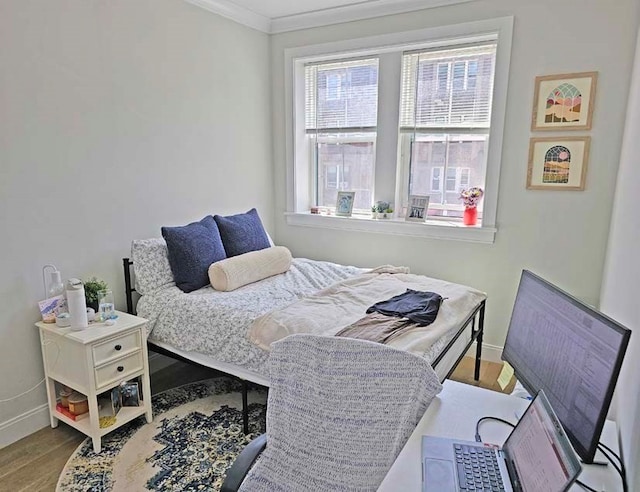 bedroom featuring ornamental molding and wood-type flooring