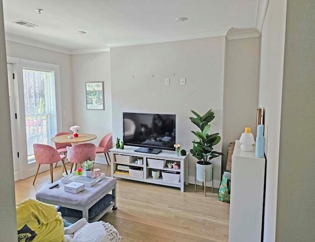 living room featuring light wood-type flooring and ornamental molding