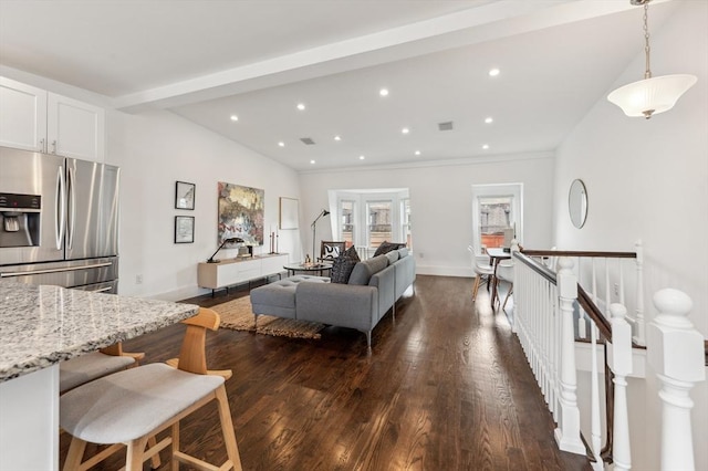 living room featuring dark hardwood / wood-style flooring and lofted ceiling with beams