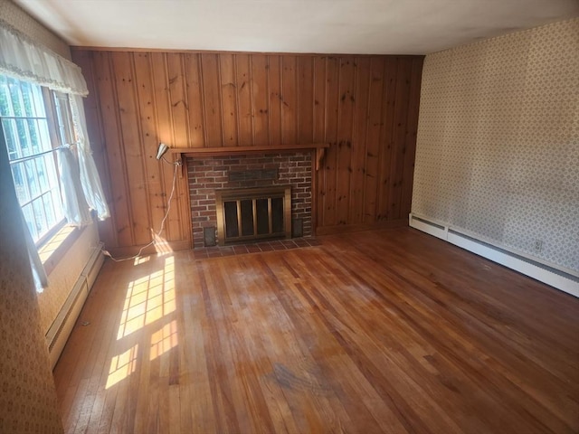 192 White St, Lunenburg, MA 01462 - unfurnished living room with baseboard heating, hardwood / wood-style flooring, a fireplace, a baseboard heating unit, and wallpapered walls