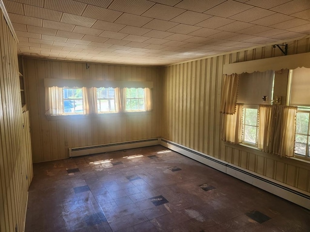 192 White St, Lunenburg, MA 01462 - empty room featuring baseboard heating, tile patterned floors, and wooden walls