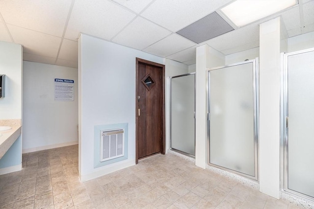 bathroom with vanity, a drop ceiling, and a shower with shower door