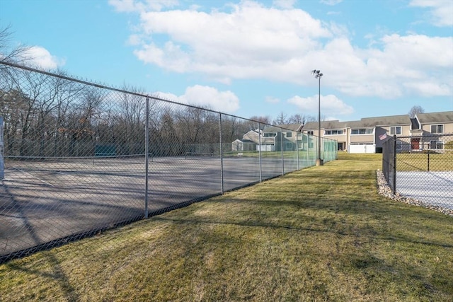 view of sport court with a yard