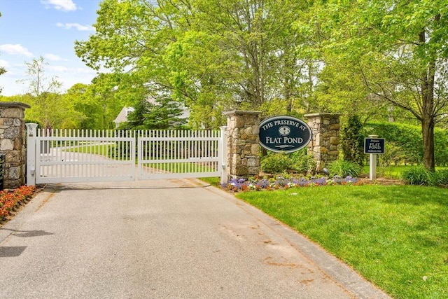 29 Flat Pond Cir, Mashpee, MA 02649 - view of asphalt street featuring a gate and a gated entry