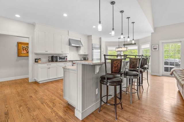 29 Flat Pond Cir, Mashpee, MA 02649 - kitchen featuring exhaust hood, light wood-style floors, a large island, stainless steel appliances, and recessed lighting