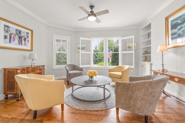29 Flat Pond Cir, Mashpee, MA 02649 - sitting room with wood finished floors, crown molding, built in features, a ceiling fan, and baseboards