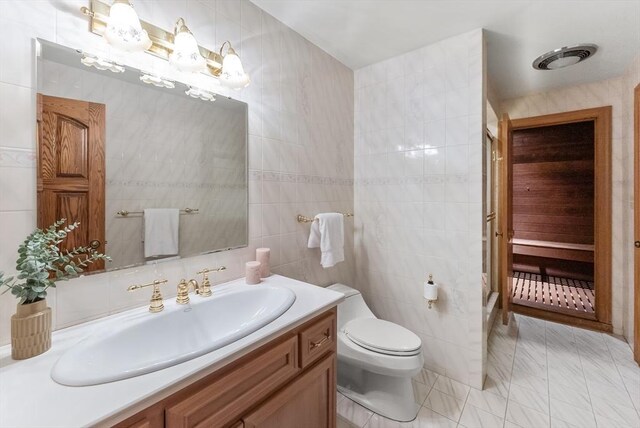 81 Countryside Ln, Milton, MA 02186 - bathroom with tile walls, vanity, toilet, and tile patterned floors