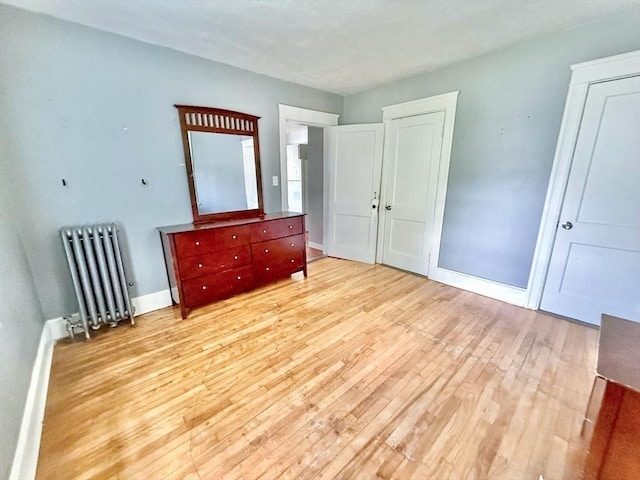 15 Circuit Ave E, Worcester, MA 01603 - bedroom with radiator heating unit, light wood-style flooring, and baseboards