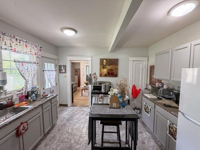 15 Circuit Ave E, Worcester, MA 01603 - kitchen featuring freestanding refrigerator, a sink, gray cabinetry, and beam ceiling