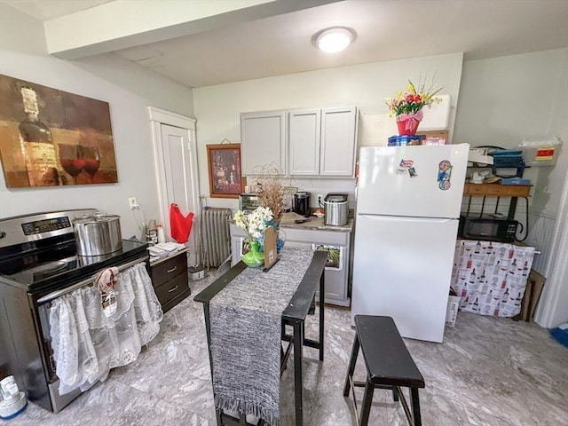 15 Circuit Ave E, Worcester, MA 01603 - kitchen featuring freestanding refrigerator, radiator heating unit, electric stove, and light countertops