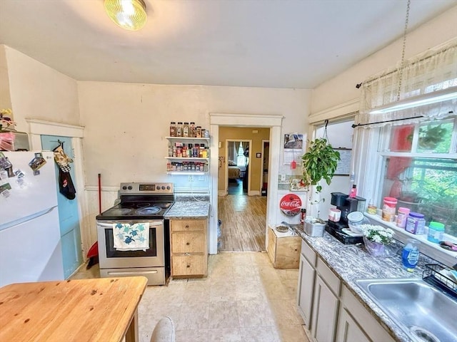 15 Circuit Ave E, Worcester, MA 01603 - kitchen featuring freestanding refrigerator, stainless steel electric stove, a sink, and light countertops