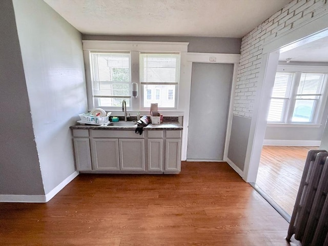 15 Circuit Ave E, Worcester, MA 01603 - kitchen with a sink, light wood finished floors, baseboards, and dark countertops