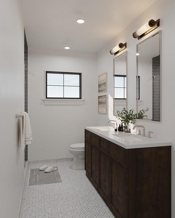 bathroom featuring plenty of natural light, toilet, double vanity, and recessed lighting