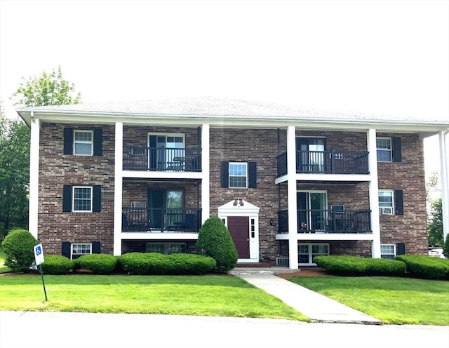 3 Walker Rd Unit 9, North Andover, MA 01845 - view of front of house with a balcony, a front yard, and brick siding