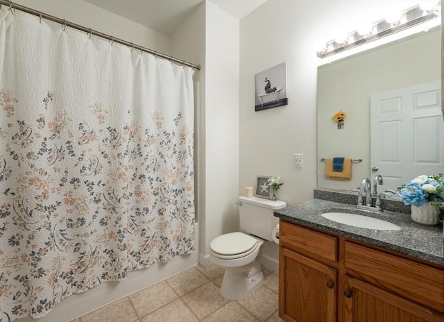 bathroom with toilet, vanity, shower / bath combo with shower curtain, tile patterned flooring, and baseboards