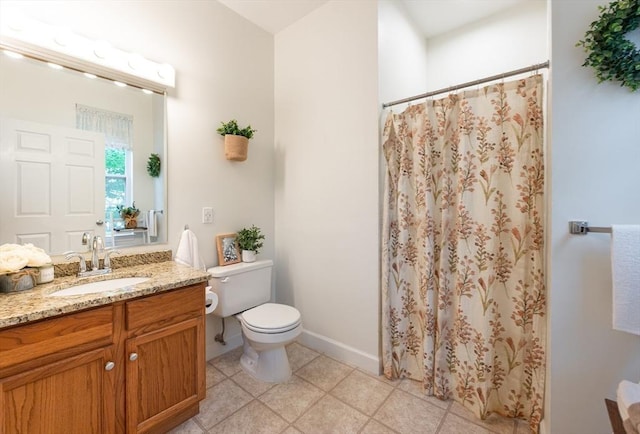 bathroom featuring toilet, vanity, curtained shower, and baseboards