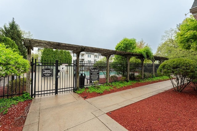view of home's community with fence, a gate, and a pergola