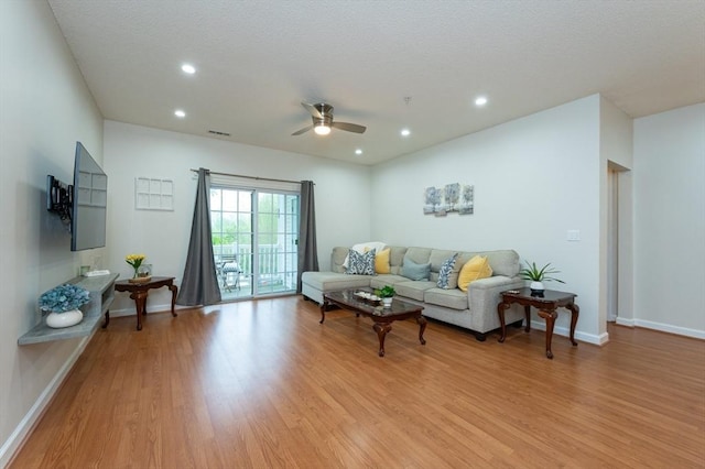 living area with light wood-style flooring, ceiling fan, baseboards, and recessed lighting