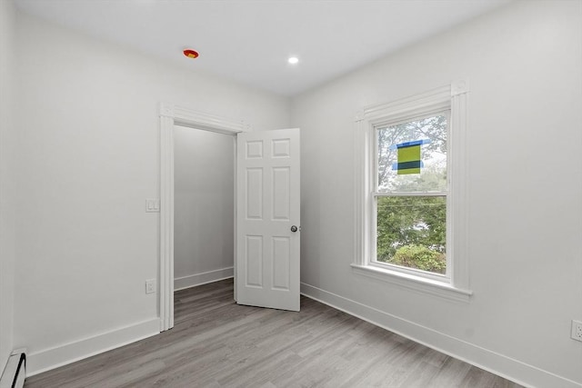 551 Chestnut St, Athol, MA 01331 - unfurnished bedroom with baseboard heating, wood finished floors, and recessed lighting