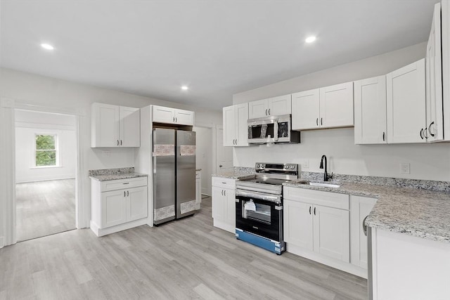 551 Chestnut St, Athol, MA 01331 - kitchen with stainless steel appliances, light wood-type flooring, white cabinetry, light stone countertops, and recessed lighting