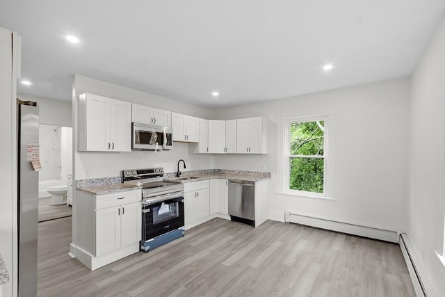551 Chestnut St, Athol, MA 01331 - kitchen with appliances with stainless steel finishes, baseboard heating, light wood-type flooring, and recessed lighting