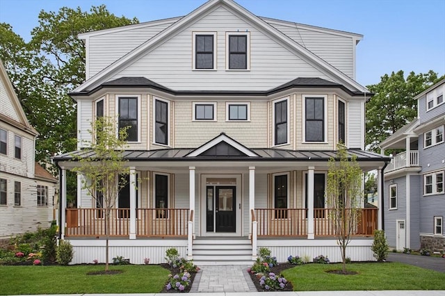 61 Lyndhurst St Unit A, Boston, MA 02124 - view of front of house featuring a standing seam roof, a porch, and a front lawn