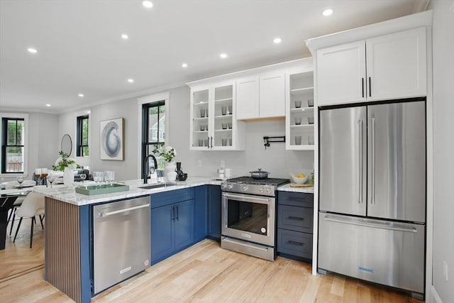 61 Lyndhurst St Unit A, Boston, MA 02124 - kitchen with stainless steel appliances, a sink, crown molding, white cabinetry, and a peninsula