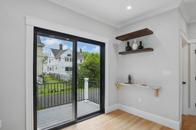 61 Lyndhurst St Unit A, Boston, MA 02124 - doorway to outside with light wood finished floors, crown molding, and baseboards