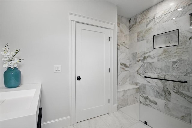 61 Lyndhurst St Unit A, Boston, MA 02124 - bathroom featuring marble look tiles, baseboards, a tile shower, and vanity