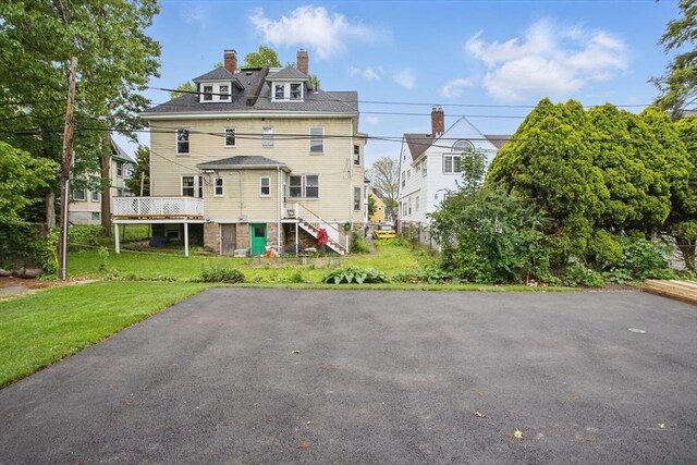 61 Lyndhurst St Unit A, Boston, MA 02124 - back of house with a chimney, stairway, and a yard