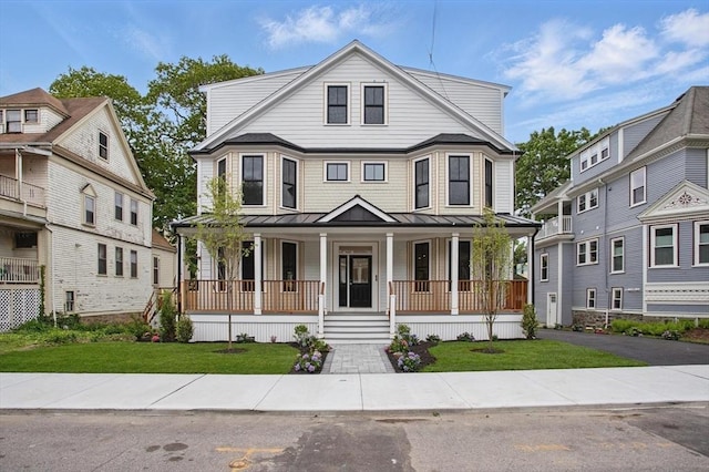61 Lyndhurst St Unit A, Boston, MA 02124 - view of front of home featuring covered porch, a standing seam roof, a front lawn, and metal roof
