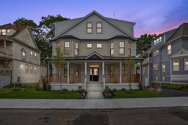 61 Lyndhurst St Unit A, Boston, MA 02124 - view of front facade with covered porch, a standing seam roof, metal roof, and a front yard
