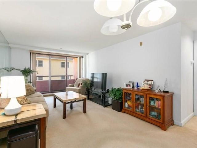 carpeted living room with ceiling fan