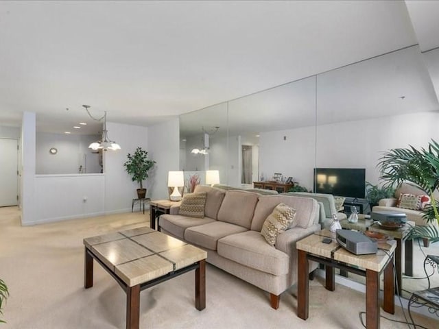 living room featuring light carpet and a chandelier