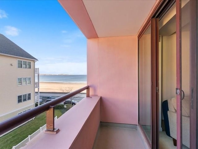 balcony with a water view and a beach view