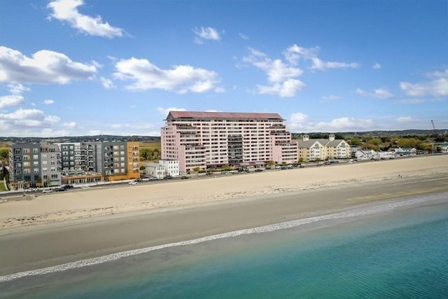 exterior space with a water view and a beach view