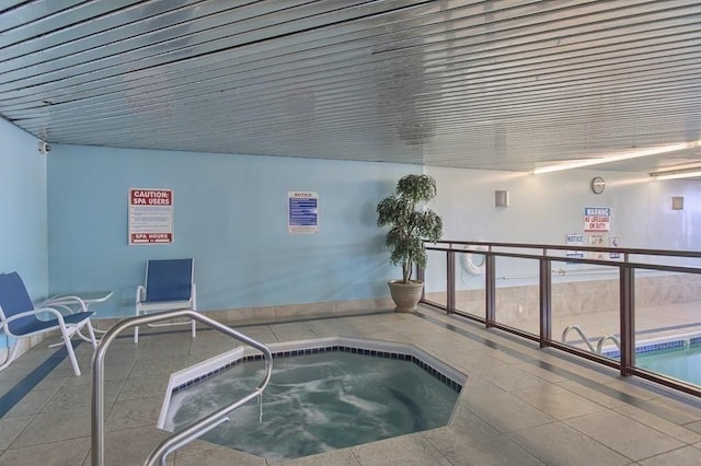 view of swimming pool with an indoor hot tub