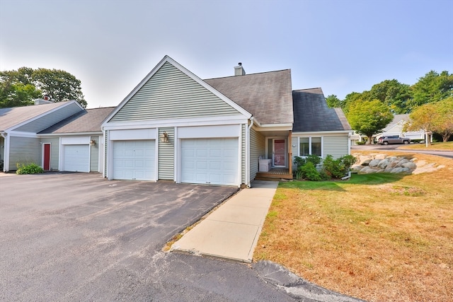 view of front of home featuring a garage and a front lawn