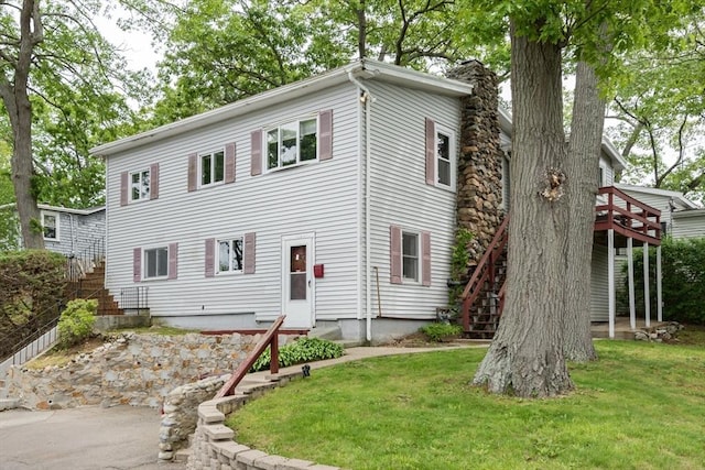 38 Colonial Rd, Weymouth, MA 02191 - view of front of home with stairway, a front yard, entry steps, and a deck
