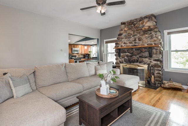 38 Colonial Rd, Weymouth, MA 02191 - living area with a ceiling fan, wood finished floors, and a stone fireplace
