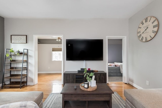 38 Colonial Rd, Weymouth, MA 02191 - living area with light wood finished floors, baseboards, and a ceiling fan