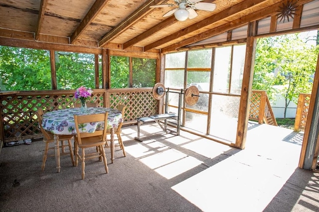 sunroom / solarium with a ceiling fan and outdoor dining area