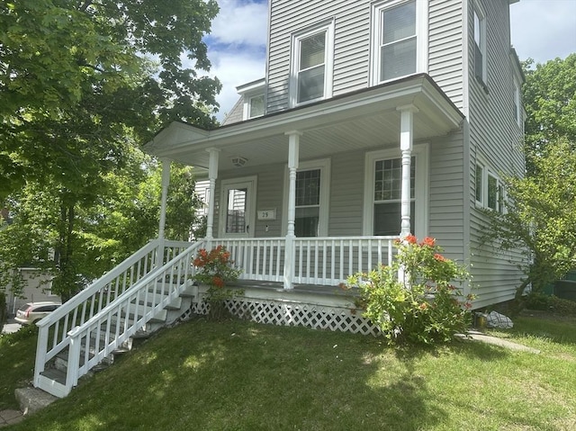 view of front of property with covered porch and a front yard